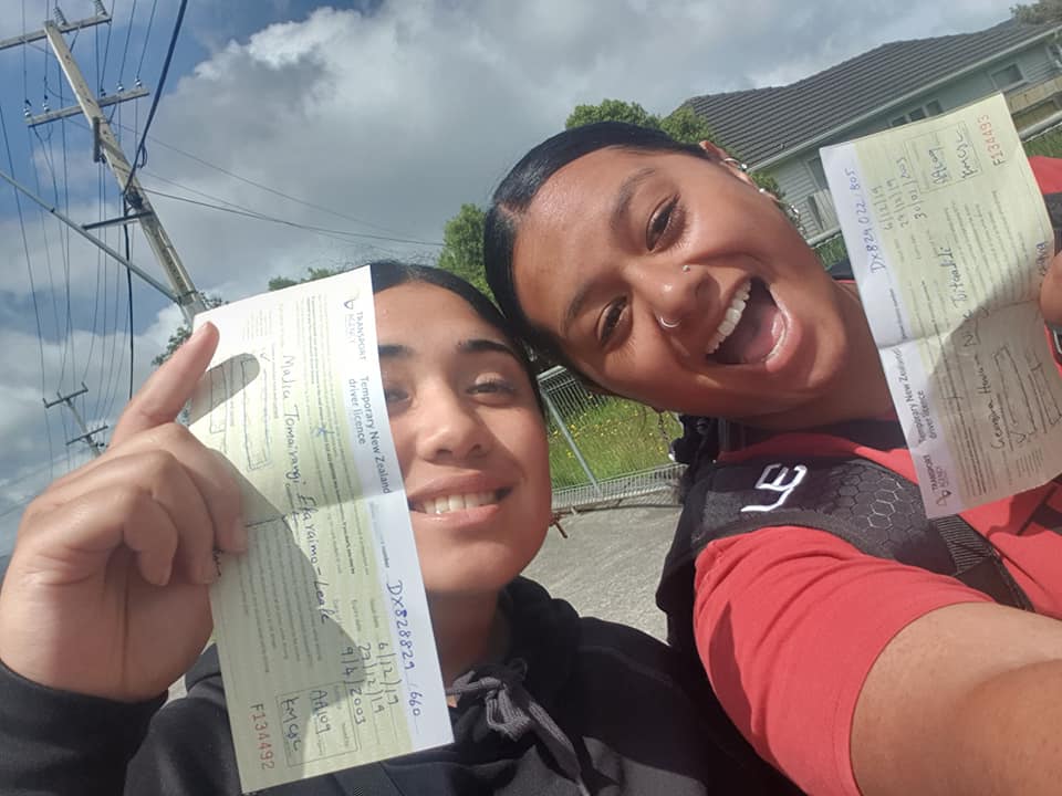 Two young kiwi girls receiving their learners drivers licences 
